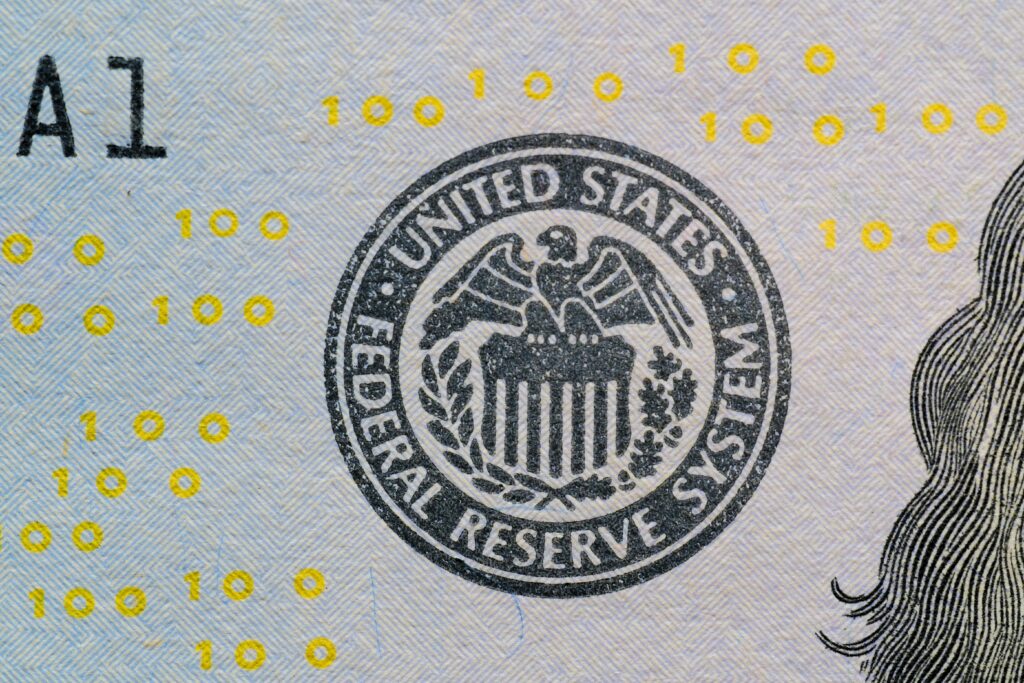 Detailed view of the US Federal Reserve System seal on currency with yellow digital numbers.